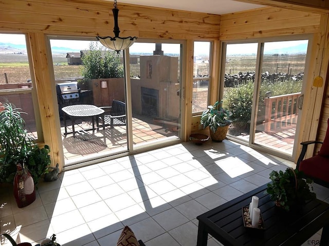 2 Inverness Ave, Westcliffe, CO 81252 - sunroom featuring plenty of natural light, tile patterned flooring, and wood walls