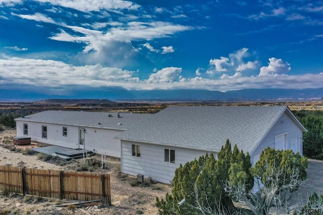 rear view of property with central AC and a deck with mountain view