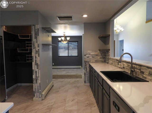 kitchen with sink, gray cabinets, appliances with stainless steel finishes, a wall unit AC, and tasteful backsplash