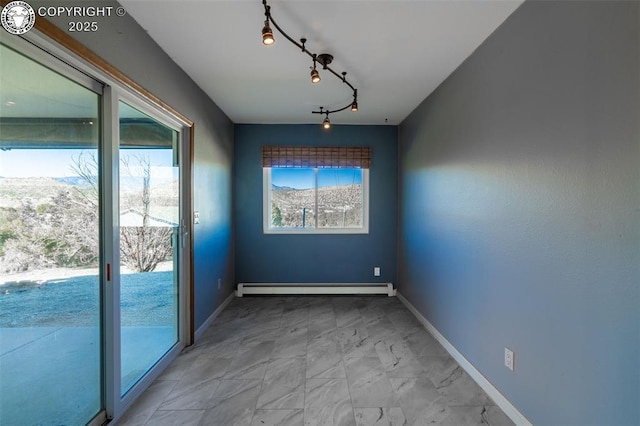 5 Cory Ln, Florence, CO 81226 - interior space with a baseboard radiator, rail lighting, baseboards, and marble finish floor