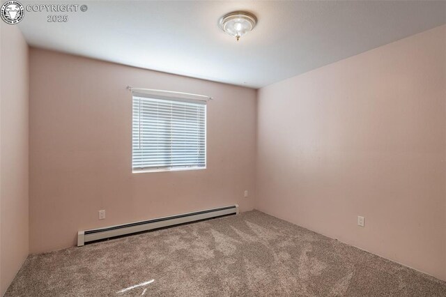 basement featuring light carpet and baseboard heating