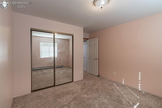 carpeted bedroom with baseboard heating