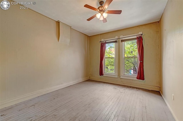 122 W Main St, Florence, CO 81226 - empty room with wood-type flooring, a ceiling fan, and baseboards
