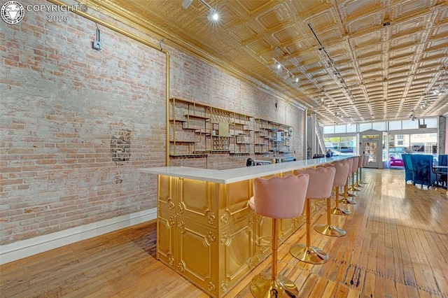 122 W Main St, Florence, CO 81226 - community bar area featuring brick wall, light wood-type flooring, and baseboards
