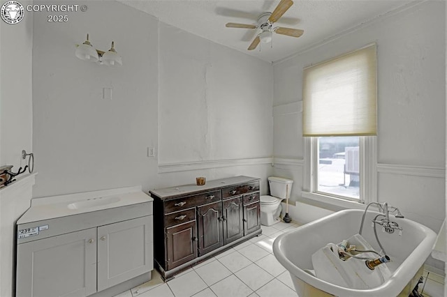 122 W Main St, Florence, CO 81226 - bathroom featuring vanity, a ceiling fan, a soaking tub, toilet, and tile patterned floors