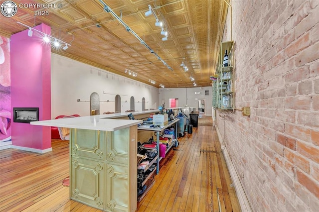 122 W Main St, Florence, CO 81226 - kitchen with light wood finished floors, brick wall, and baseboards