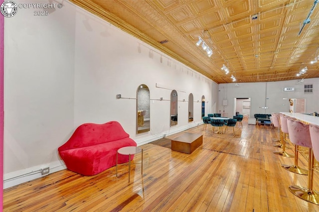 122 W Main St, Florence, CO 81226 - sitting room featuring hardwood / wood-style floors, an ornate ceiling, and baseboards