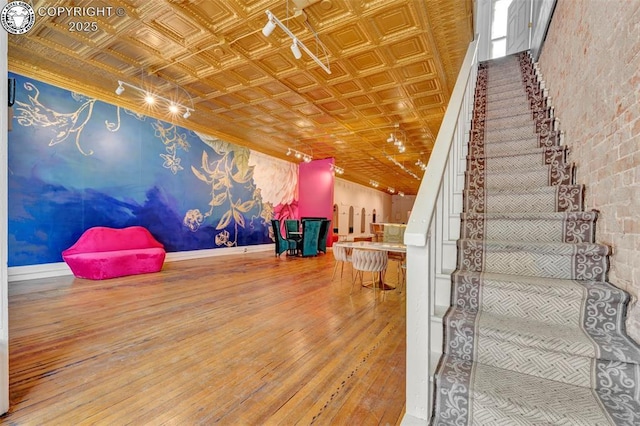 122 W Main St, Florence, CO 81226 - stairway with an ornate ceiling, hardwood / wood-style flooring, and baseboards