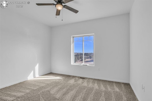 unfurnished room with ceiling fan and carpet