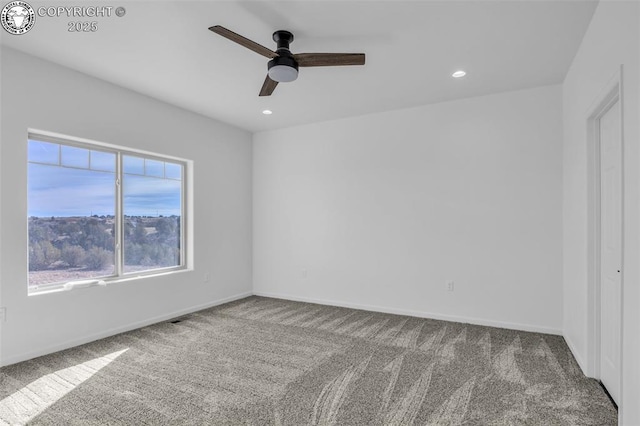 spare room with carpet and ceiling fan