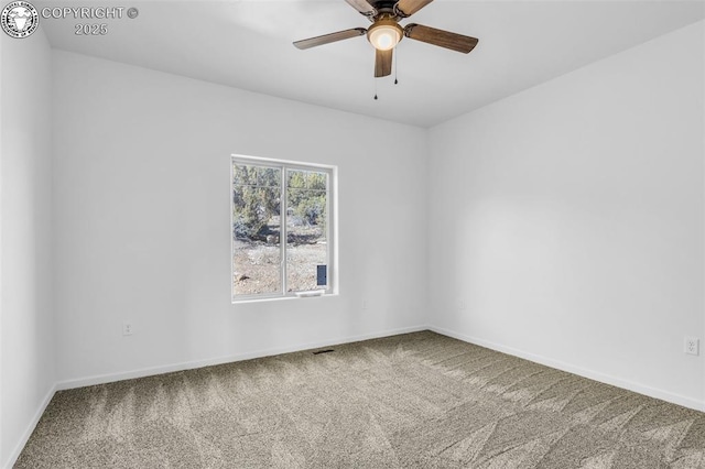 unfurnished room with ceiling fan and carpet