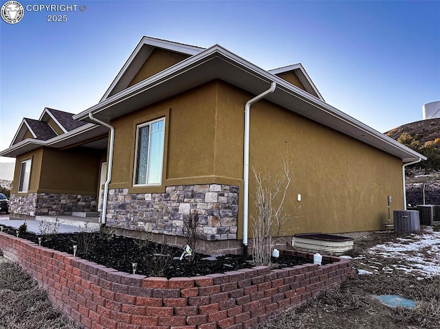 view of side of property with central AC