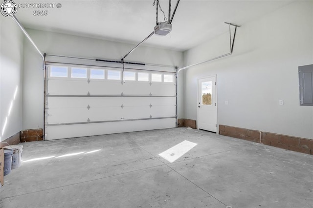 garage with a garage door opener and electric panel