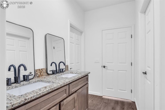 bathroom featuring vanity and hardwood / wood-style flooring