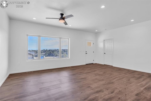 unfurnished living room with dark wood-type flooring and ceiling fan