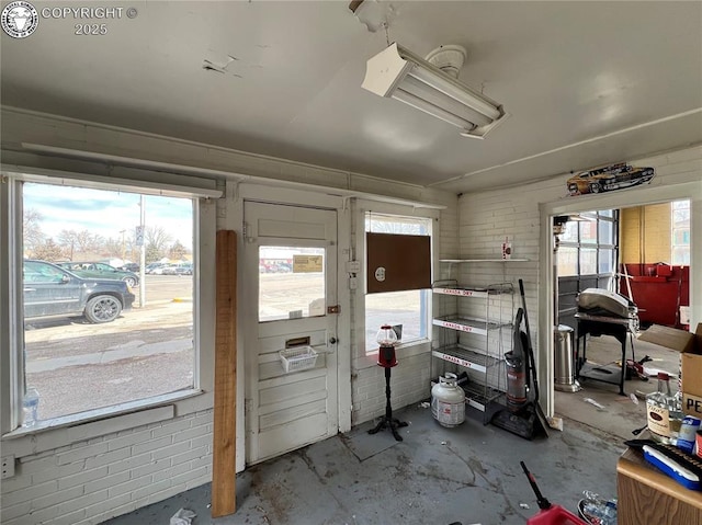 interior space with concrete flooring and brick wall