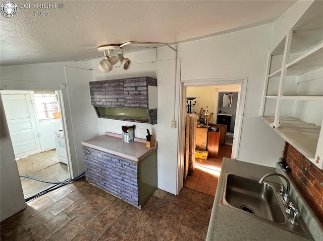 kitchen featuring sink and a textured ceiling