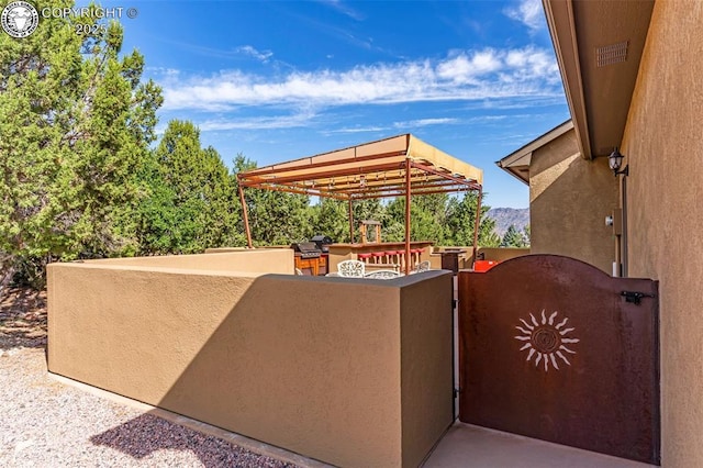 view of patio / terrace featuring an outdoor bar