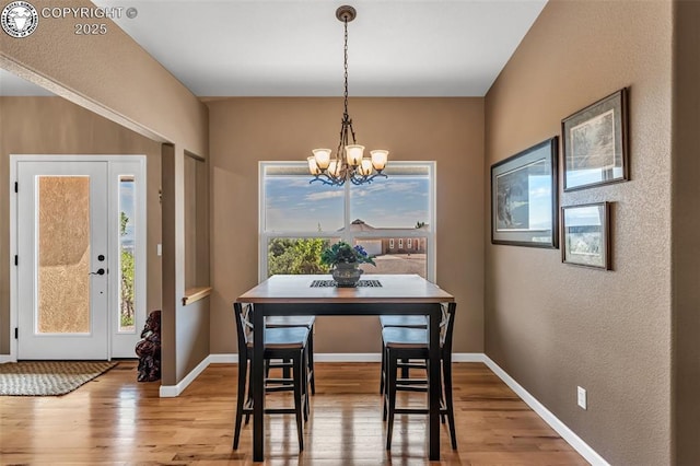 dining area featuring a notable chandelier and hardwood / wood-style flooring