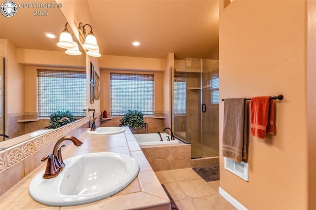 bathroom featuring plus walk in shower, tile patterned floors, a chandelier, and vanity