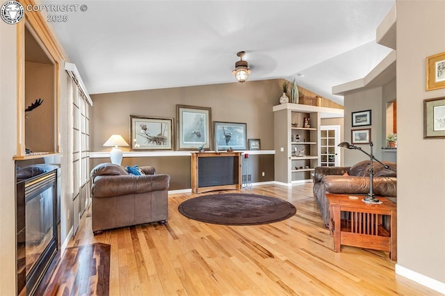 living room with lofted ceiling and hardwood / wood-style floors