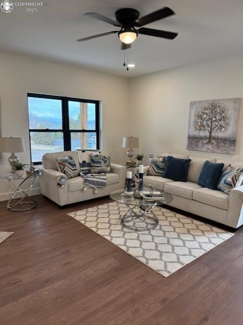 living room featuring hardwood / wood-style floors and ceiling fan