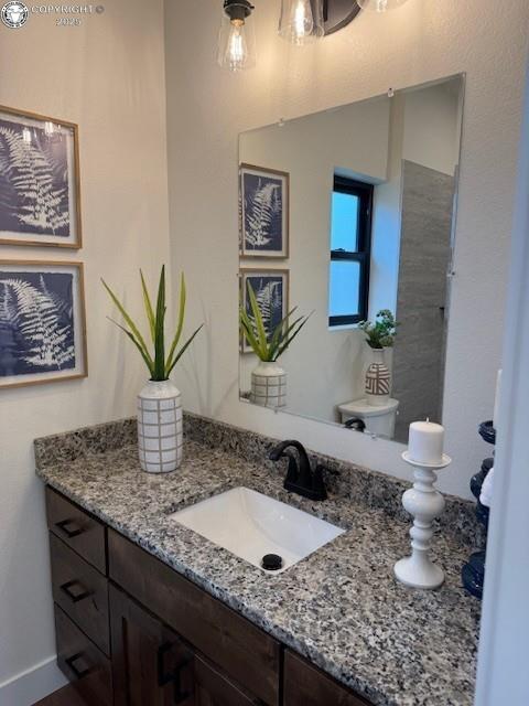 bathroom featuring toilet and vanity