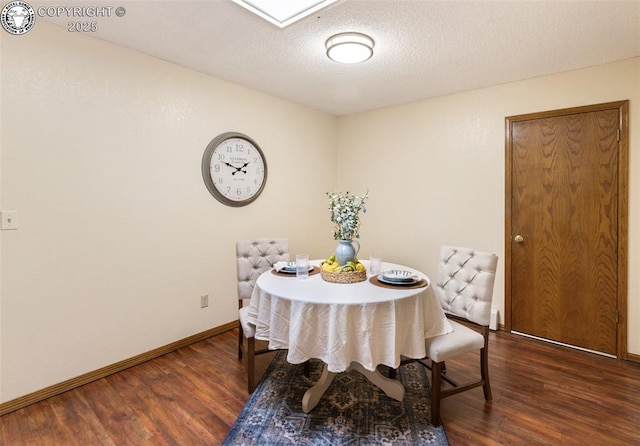 1125 Barr Ave, Canon City, CO 81212 - dining room featuring dark wood-type flooring and a textured ceiling
