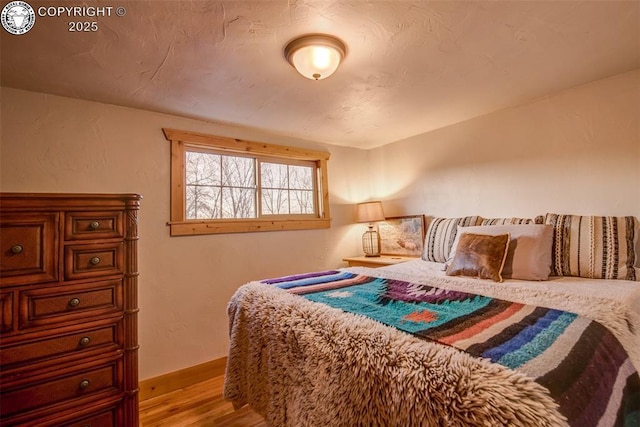 bedroom with light wood finished floors