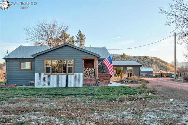 view of front of property with roof with shingles and a mountain view