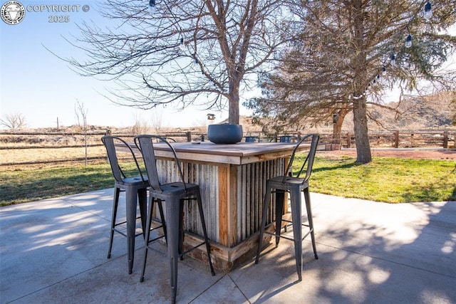 view of patio / terrace with fence and outdoor dry bar