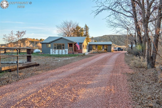 view of front of house with driveway and a mountain view