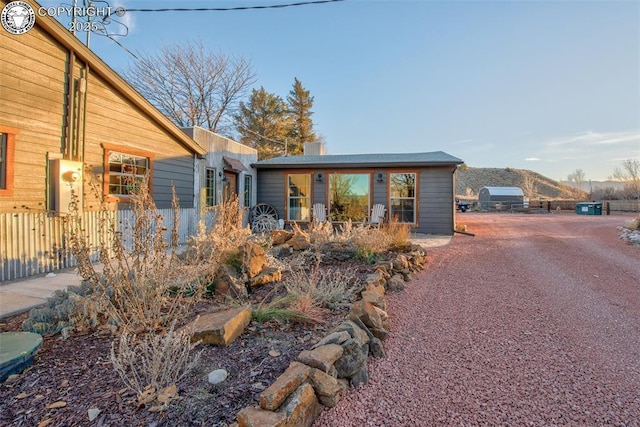 exterior space featuring fence and a mountain view