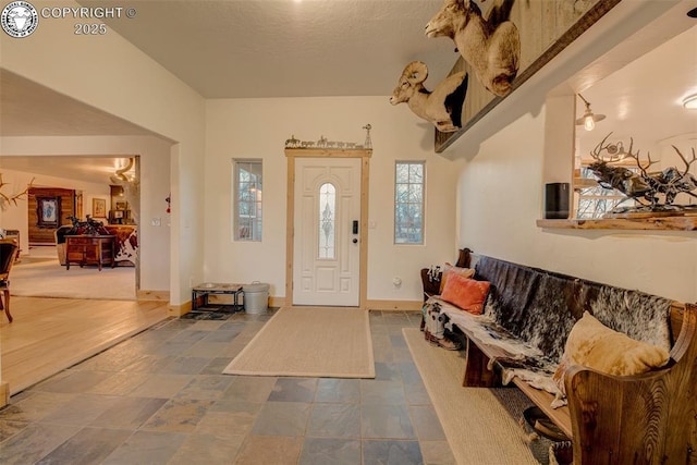 foyer featuring baseboards