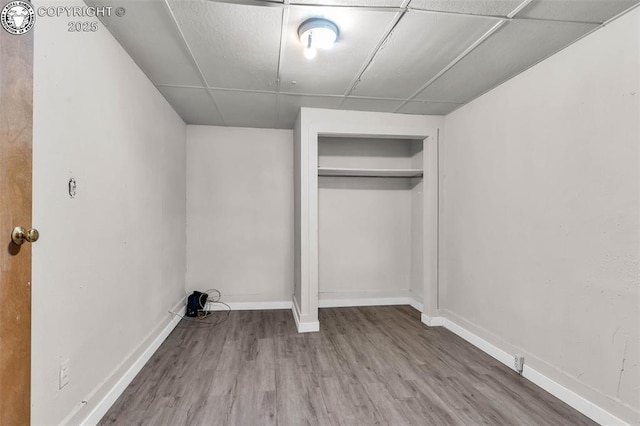 laundry area with baseboards and wood finished floors