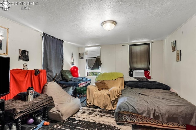bedroom featuring cooling unit and a textured ceiling