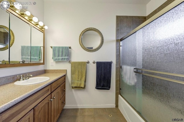 bathroom featuring tile patterned floors, vanity, and bath / shower combo with glass door