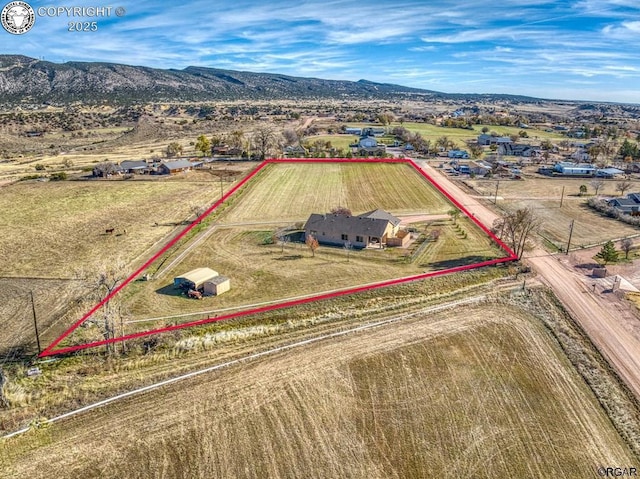 birds eye view of property with a rural view and a mountain view