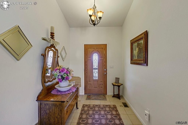 foyer entrance featuring light tile patterned floors and a chandelier