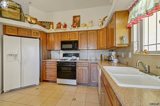 kitchen featuring sink, light tile patterned floors, white appliances, and decorative backsplash