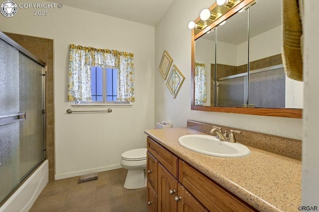 full bathroom featuring enclosed tub / shower combo, vanity, tile patterned floors, and toilet