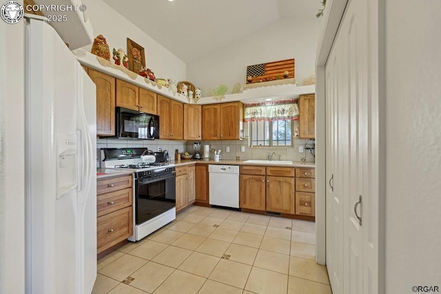 kitchen with lofted ceiling, sink, white appliances, light tile patterned floors, and decorative backsplash