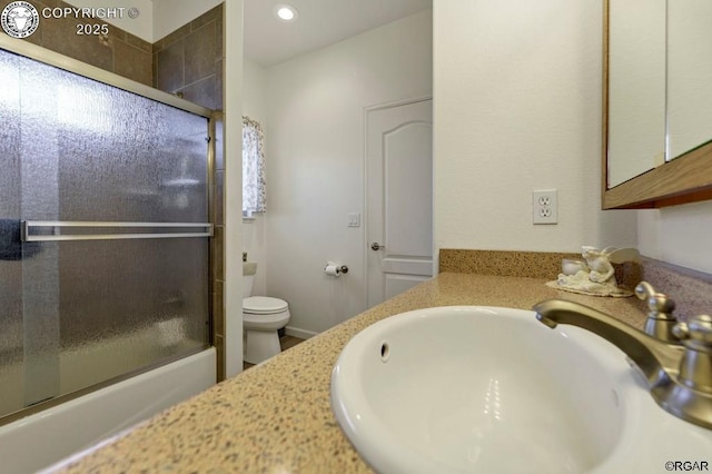 full bathroom featuring shower / bath combination with glass door, vanity, and toilet