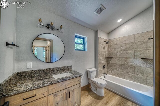 79 Terrazo Abajo, Westcliffe, CO 81252 - full bathroom featuring wood finished floors, vanity, lofted ceiling, tub / shower combination, and a textured wall