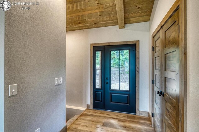 79 Terrazo Abajo, Westcliffe, CO 81252 - entryway with a wood ceiling with exposed beams, a textured wall, and wood finished floors