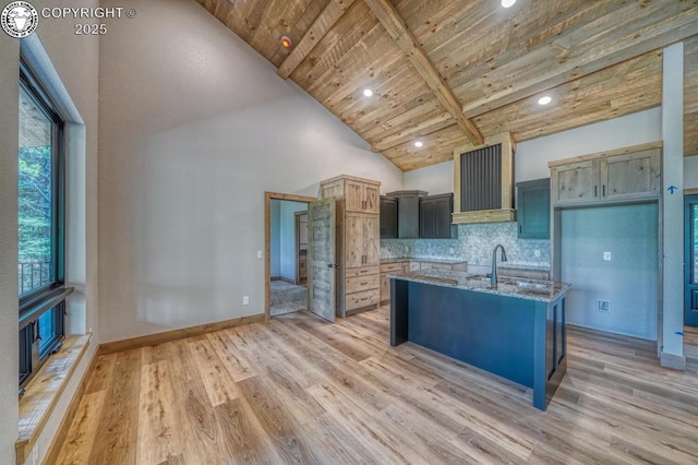 79 Terrazo Abajo, Westcliffe, CO 81252 - kitchen with ventilation hood, a wood ceiling with exposed beams, light wood-style flooring, stone counters, and backsplash