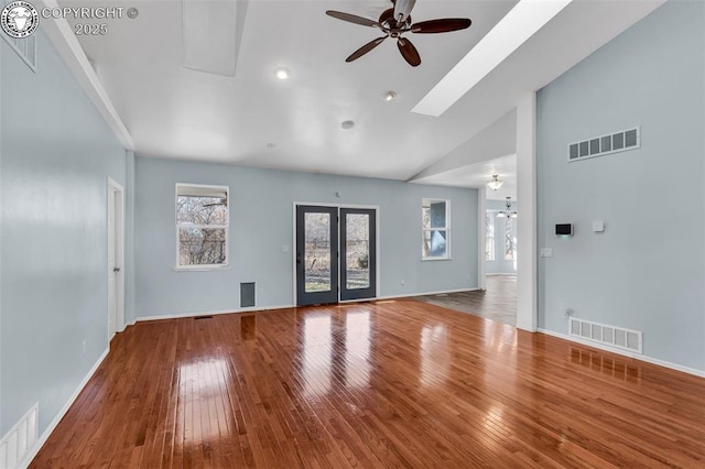 unfurnished living room featuring visible vents, ceiling fan, and wood finished floors