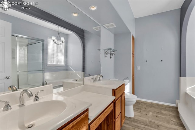 bathroom featuring visible vents, toilet, a stall shower, wood finished floors, and a bath