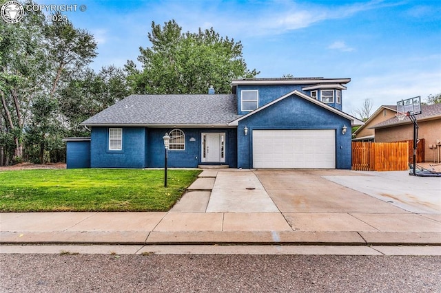 traditional-style house featuring a garage, driveway, a front lawn, and stucco siding