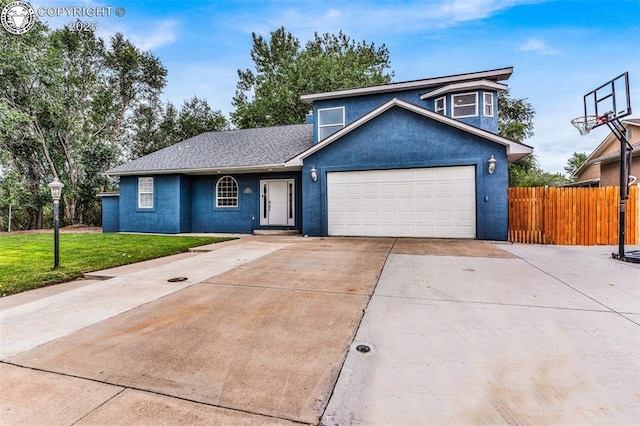 view of front facade with an attached garage, fence, driveway, stucco siding, and a front yard